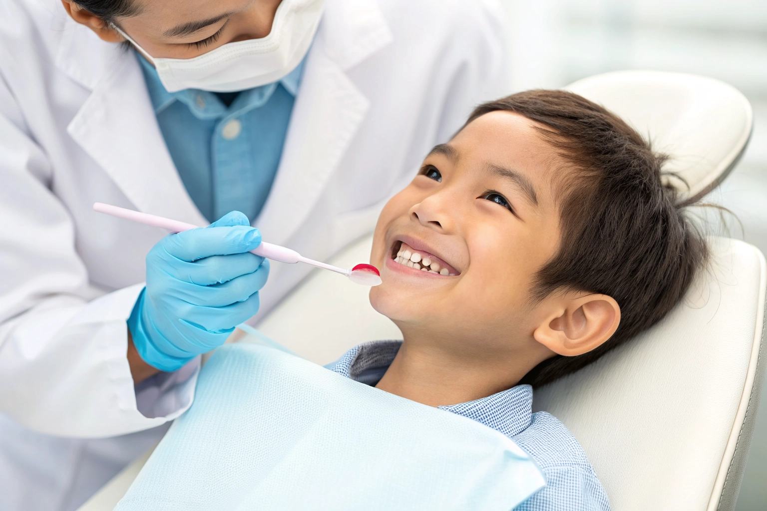 A child receiving a gentle dental cleaning treatment.